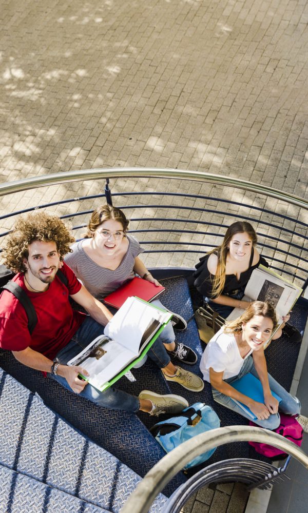 students-sitting-with-books-stairs
